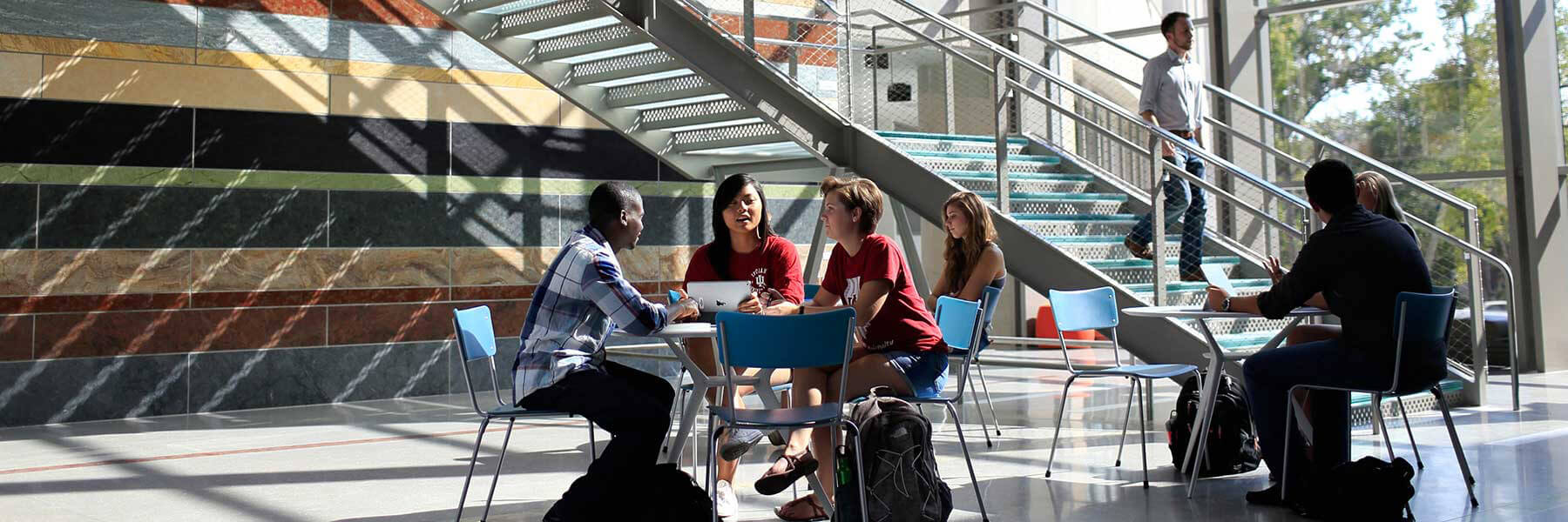 Students having a discussion at a table in the HLS Atrium